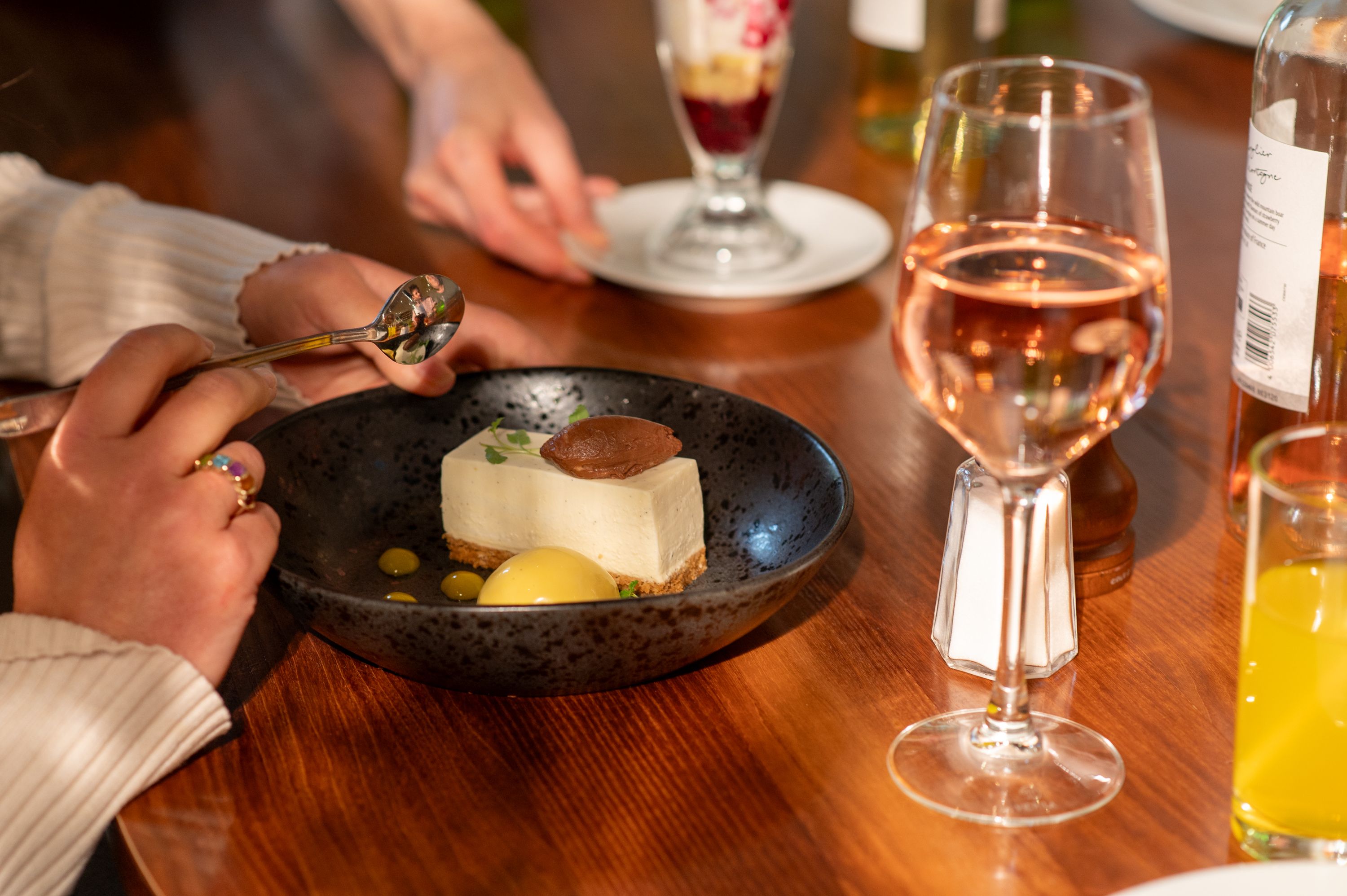 A bowl of dessert accompanied by wine